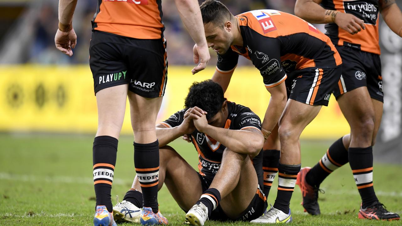 Asu Kepaoa is consoled by Tigers teammates after the match. Picture: NRL Photos