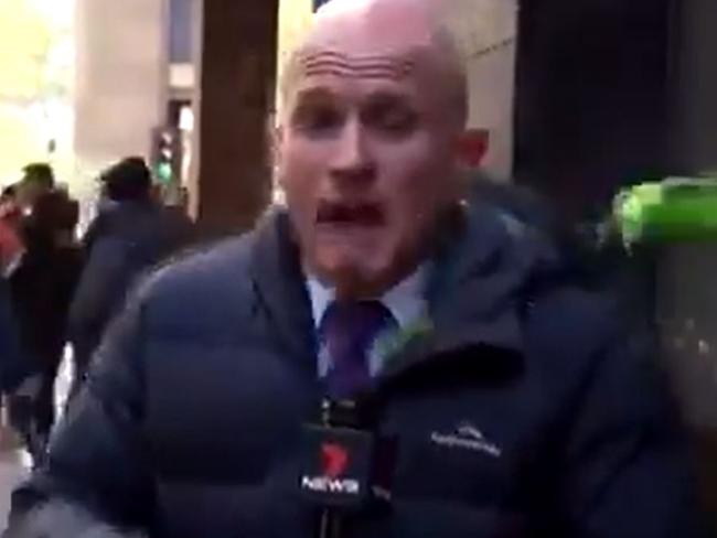 The moment Channel 7 reporter Paul Dowsley is hit by a can of drink at Melbourne's anti-vax rally on Tuesday. Picture: Channel 7