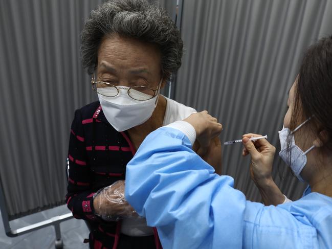 An elderly South Korean woman receives the first dose of the Pfizer-BioNTech vaccine in Seoul. Picture: Getty Images