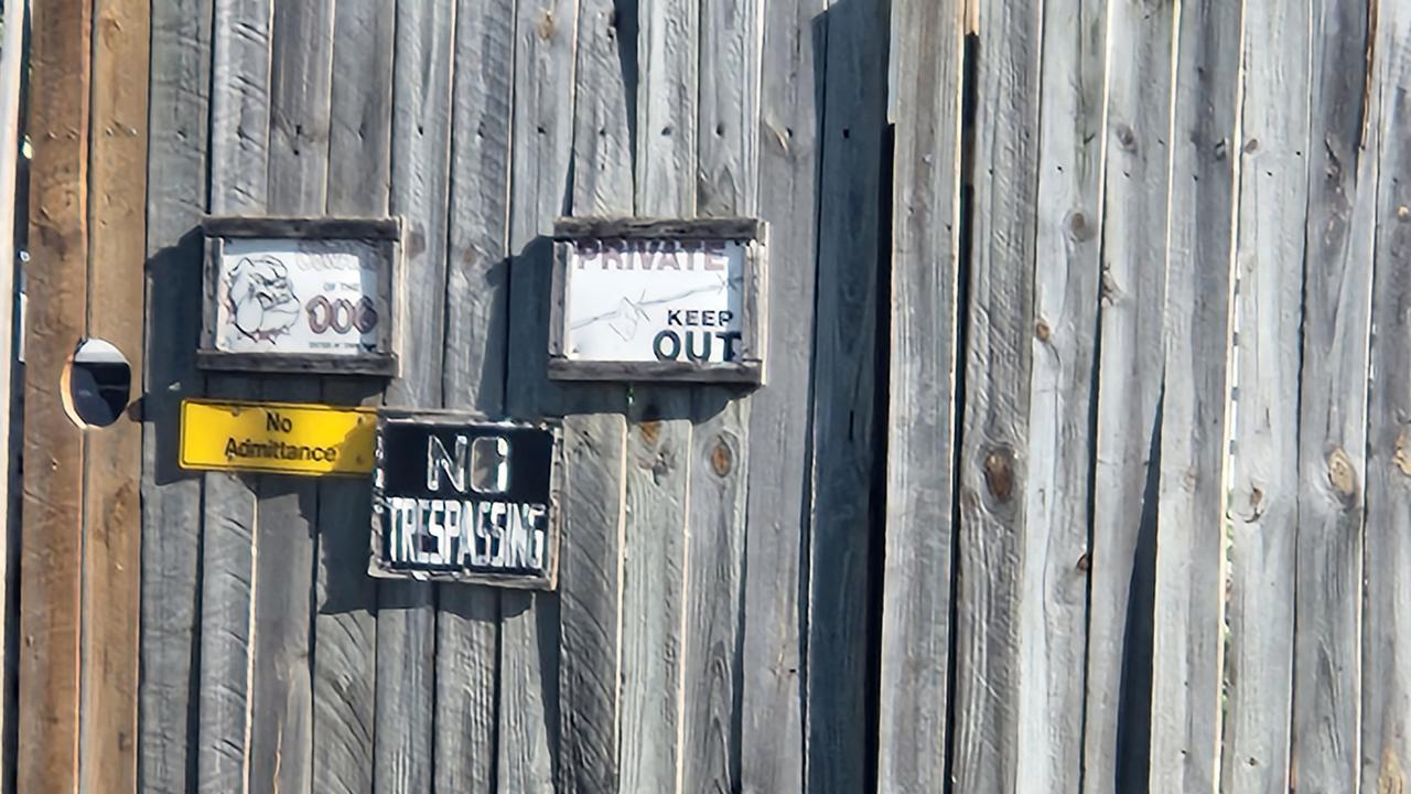 Signs on the front gate at the Bank Street house, Park Avenue, North Rockhampton, on Sunday, September 11, 2022.