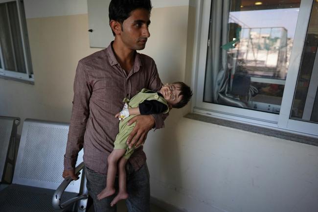 Palestinian children suffering malnutrition or chronic diseases wait with family members in the southern Gaza Strip after they reportedly received permission from the Israeli army to leave the besieged Palestinian territory