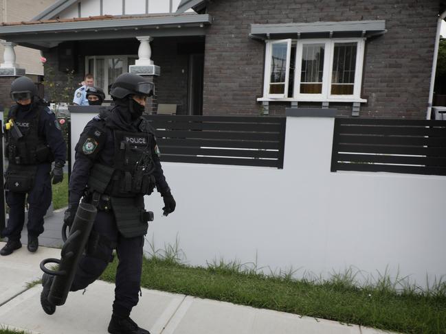 Specialist police raid the home in Bankstown.