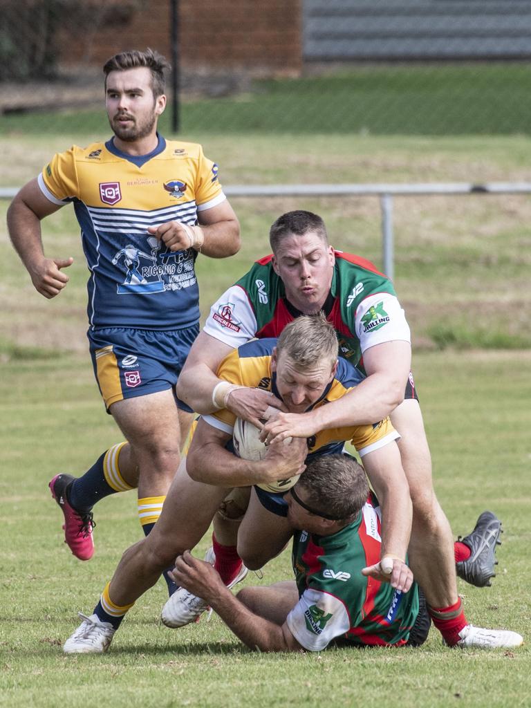 Carl Clement for Hawks tackled by Nicholas Nairn and Cameron Millar for Danes. Pictures: Nev Madsen.