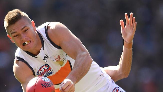 Adam Tomlinson shoots out a handball during the grand final, his last game for the Giants. Picture: Quinn Rooney/Getty Images.