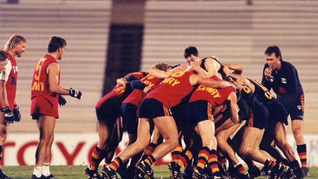 Coach Robert Shaw oversees the Crows in a rugby scrum at training in 1995.