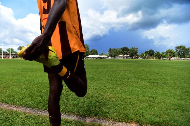 A Tapalinga Superstars player stays loose during the grand final match against the Ranku Eahles during this year's 49th Annual Tiwi Grand Final on Bathurst Island, 80km's north of Darwin, NT. Picture: Justin Kennedy