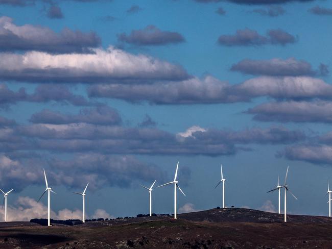 Clouds can be seen above power-generating wind turbines at the Capital Wind Farm, located at Lake George, near the town of Bungendore on March 25, 2025. (Photo by DAVID GRAY / AFP)