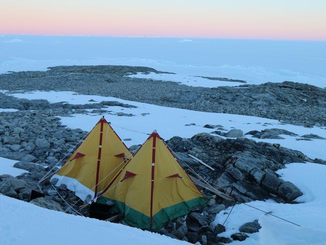 Expeditioners' polar pyramid tents pictured as the northern sky glows red from the setting sun. Picture: David Killick