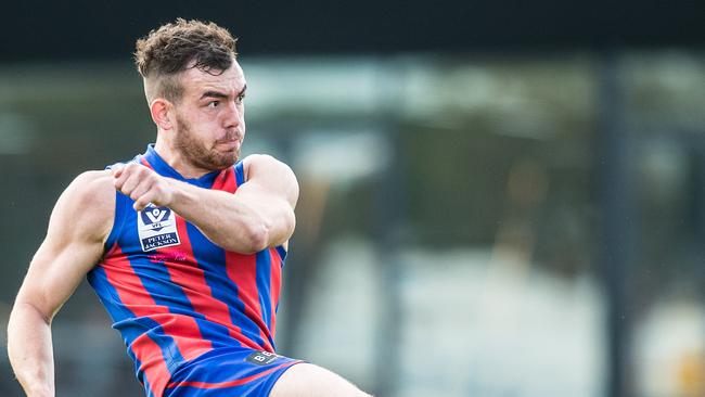 Luke Tynan taking a clearing kick for Port Melbourne.