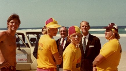 His Royal Highness Prince Philip, Duke of Edinburgh with Surf Lifesavers on Surfers Paradise Beach, Gold Coast, Queensland, October 1982. Picture: Pauline Holley (Image courtesy of the City of Gold Coast Local Studies Library)
