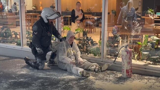 Police arrest an Extinction Rebellion protester outside the Santos building in Adelaide. Picture: Supplied