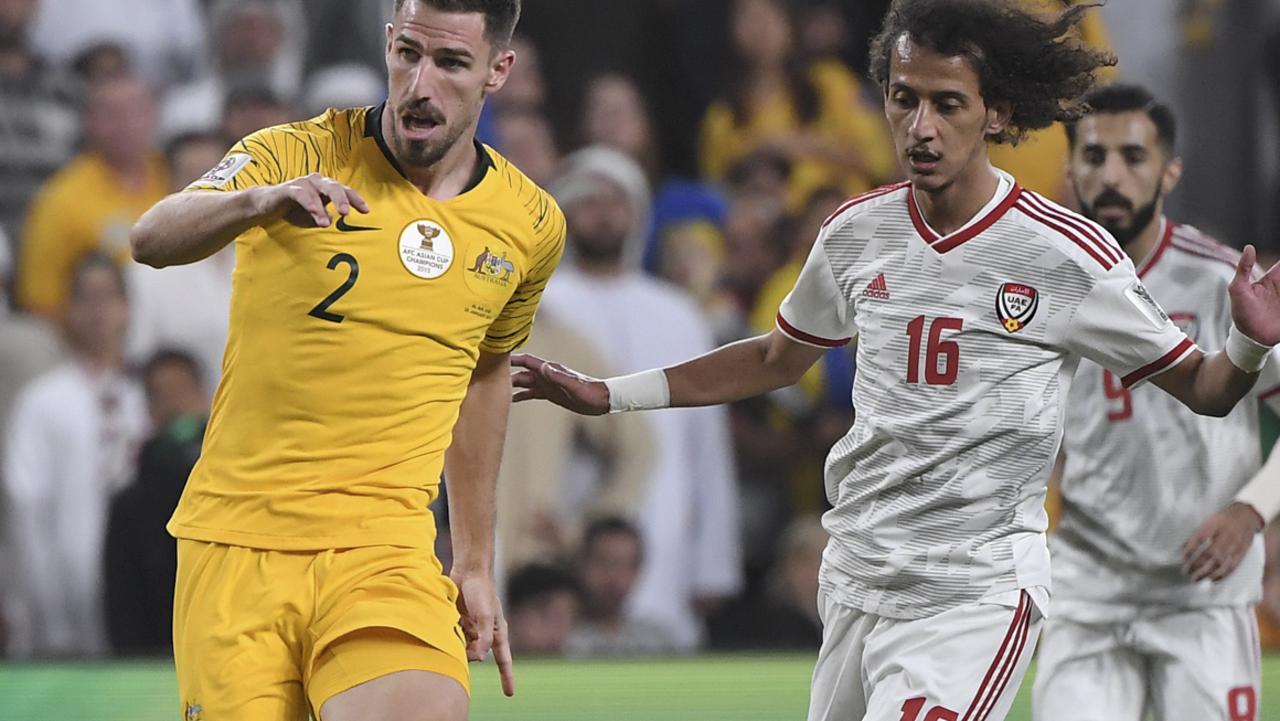 Australia's defender Milos Degenek, left, makes a wrong pass to his goalkeeper Mat Ryan as United Arab Emirates' midfielder Mohammed Abdulrah, right, looks on during the AFC Asian Cup quarterfinal soccer match between United Arab Emirates and Australia at Hazza Bin Zayed Stadium in Al Ain, United Arab Emirates, Friday, Jan. 25, 2019. (AP Photo/Hassan Ammar)