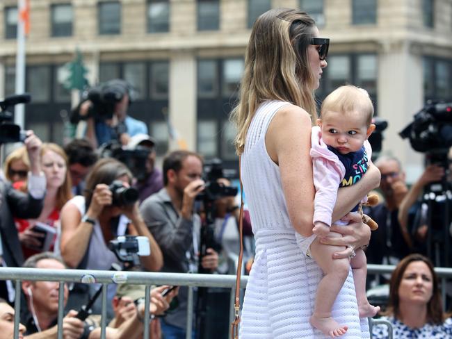 One of deceased financier Jeffrey Epstein's alleged victims and her baby listen to discrimination attorney Gloria Allred talk to the press outside the US Federal Court. Picture: AFP