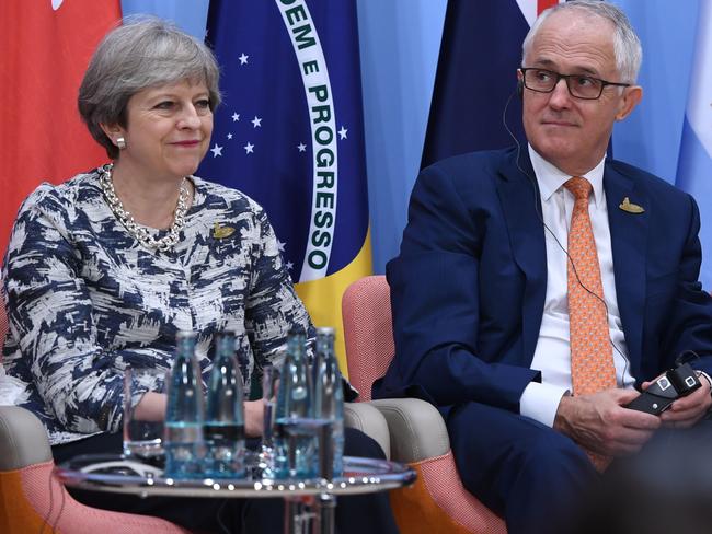 (L to R) Britain's Prime Minister Theresa May, Australia's Prime Minister Malcolm Turnbull and Japan's Prime Minister Shinzo Abe attend the panel discussion 