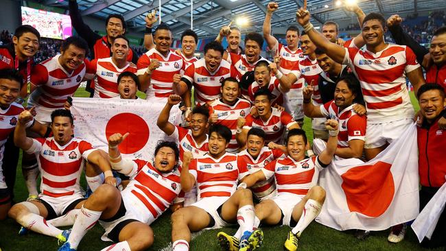 Japan's players celebrate after their historic World Cup victory against South Africa.