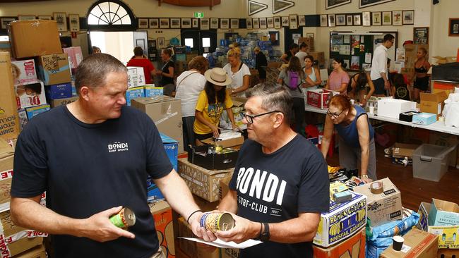 Club President Brent Jackson and Brent Patinson of Bondi Bathers Surf Lifesaving Club sort through donations as volunteers take receipt of relief items. Bondi Surf Bathers Life Saving Club has been inundated with donations after setting up as a bushfire relief centre. Picture: John Appleyard