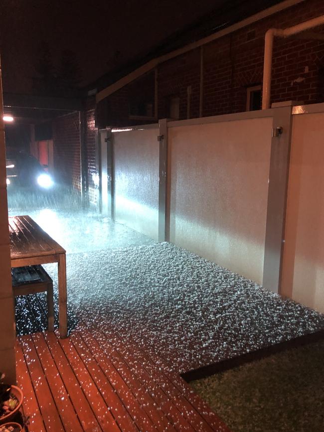 Hail blankets a deck in Glenelg North on Wednesday night. Picture: Dan Demaria