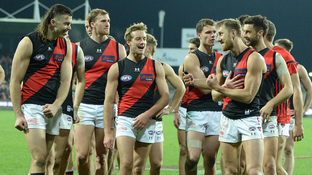 Dyson Heppell leads the Bombers off after beating Hawthorn in Launceston.