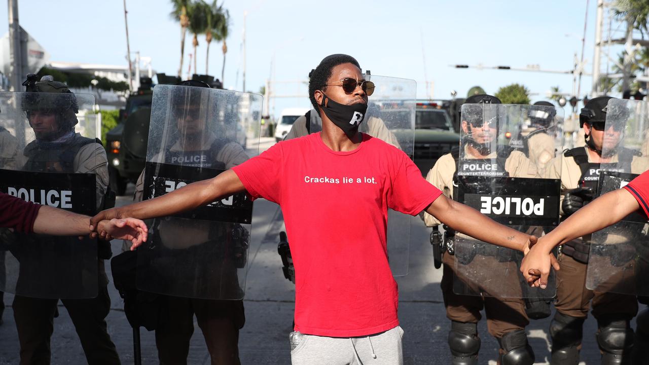 Police hold a perimeter as demonstrators protest in Miami, Florida. Picture: AFP