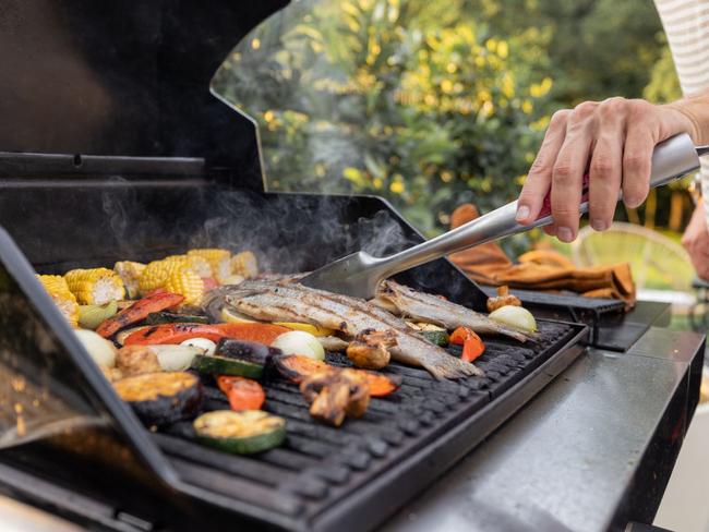 Enjoy deliciously grilled meals from the comfort of your backyard with these top-rated barbecues. Image: iStock.