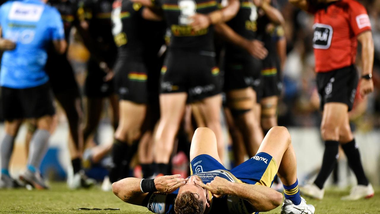 MACKAY, AUSTRALIA - SEPTEMBER 18: Bryce Cartwright of the Eels looks dejected after defeat as the Panthers celebrate victory during the NRL semi-final match between the Penrith Panthers and the Parramatta Eels at BB Print Stadium on September 18, 2021 in Mackay, Australia. (Photo by Matt Roberts/Getty Images)