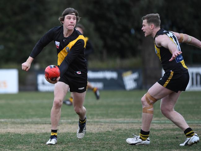 Michael Barro feeds out a handball. Picture: James Ross/AAP