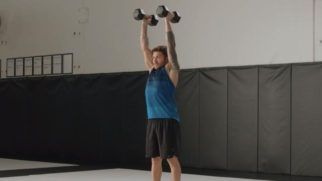 Luke Zocchi demonstrates the burpee curl to press in the Centr app.