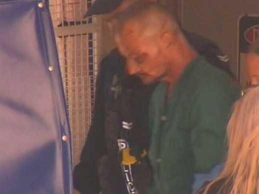 Ben Hoffmann led away from hospital to the Darwin watch house. Picture: Nine News