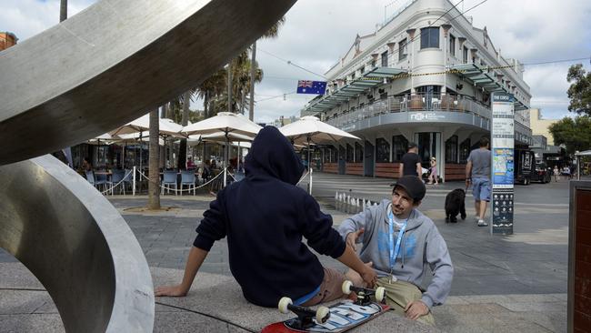 Thomas Dent, from the StreetWork program, meets a young person on the Corso at Manly. They have set up an office out of the Manly Uniting Church. Picture: Troy Snook