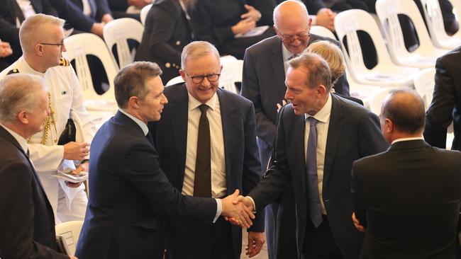 Former Prime Minister Tony Abbott shakes the hand of Labor minister Jason Clare. Picture: Toby Zerna