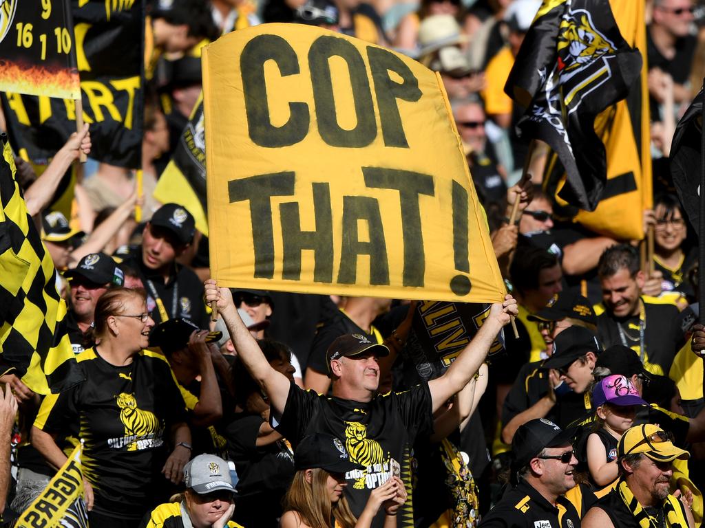 Tiger fans celebrate a goal during the Round 3 AFL match between the Richmond Tigers and the Hawthorn Hawks at the MCG in Melbourne, Sunday, April 8, 2018. (AAP Image/Joe Castro) NO ARCHIVING, EDITORIAL USE ONLY