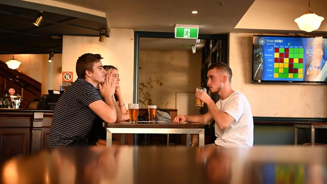 Patrons drink beer at a pub in the Rocks area of Sydney today. Picture: AFP