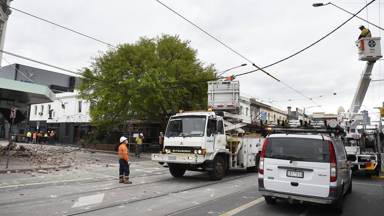 Maintenance crews work on overhead power lines on Chapel St. Picture: Andrew Henshaw