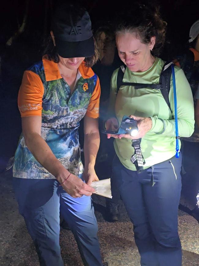 Townsville Hike and Explore members Syl and Deb Gravener holding the message contained in the Schweppes bottle set adrift from Navini Island Resort in Fiji by three girls from Sunnyvale, California, eight years ago. Picture: Supplied