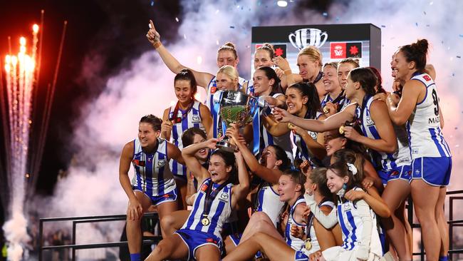 MELBOURNE, AUSTRALIA - NOVEMBER 30: Kangaroos players hold the premiership cup aloft following the AFLW Grand Final match between North Melbourne Tasmanian Kangaroos and Brisbane Lions at Ikon Park, on November 30, 2024, in Melbourne, Australia. (Photo by Morgan Hancock/AFL Photos/via Getty Images) *** BESTPIX ***