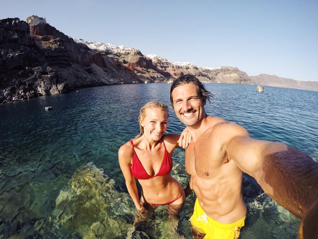 Tim and Anna enjoying Red Beach in Santorini. Picture: Tim Robards