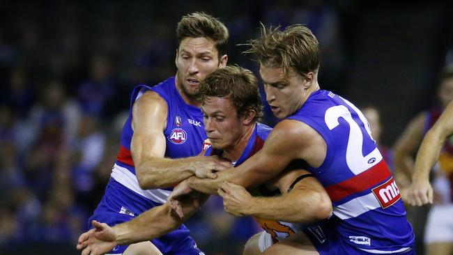 AFL: Round 5 Western Bulldogs V Brisbane Lions at Etihad Stadium, Brisbane Lions' Ryan Lester gets tackled by (L) Matthew Boyd and (r) Shane Biggs. 23rd April 2016. Picture: Colleen Petch.