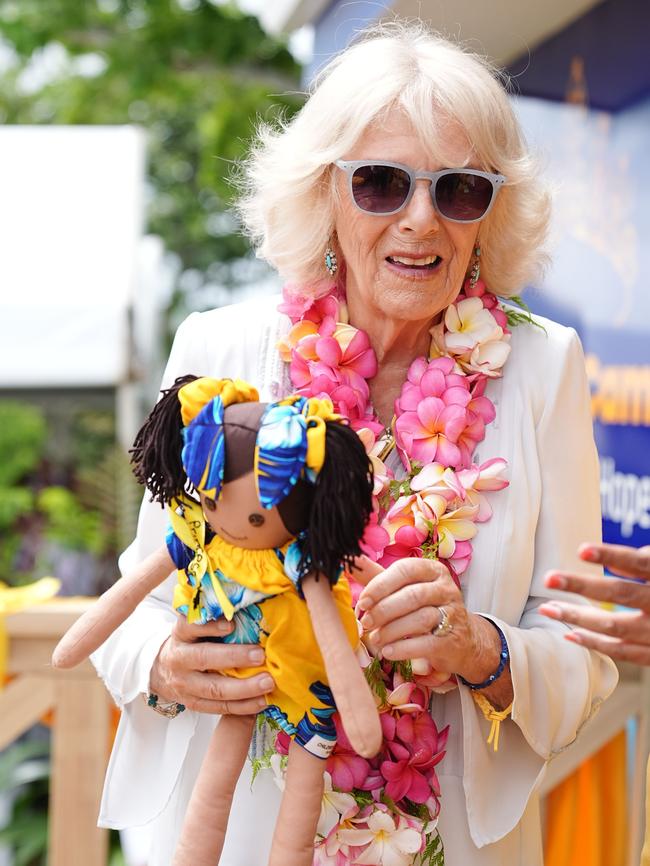 Queen Camilla collects gifts from the locals. Picture: Getty Images