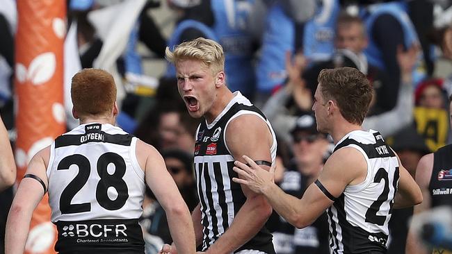 Billy Frampton celebrates his goal with Willem Drew and Kane Farrell in the SANFL grand final. Picture SARAH REED