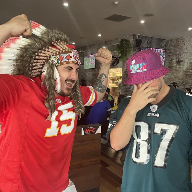 Chiefs fan Leon Suckling gives Eagles fan Jimmi Thompson a serve at an NFL Super Bowl watch party. Picture: Nic Darveniza