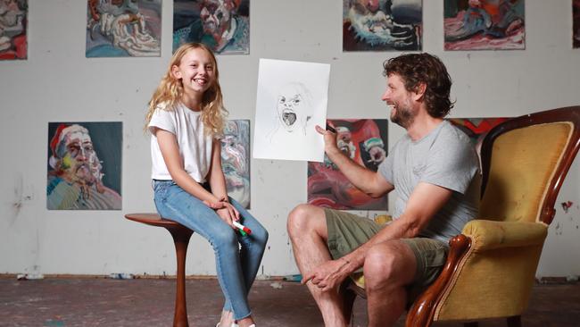 Ben Quilty and his daughter Livvy in the artist’s Mittagong studio working on capturing Livvy ‘surprised face’. Picture: John Feder