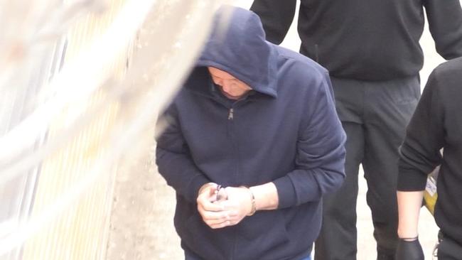 Former SA police officer Kym Parsons is led into court. Picture: Nine News