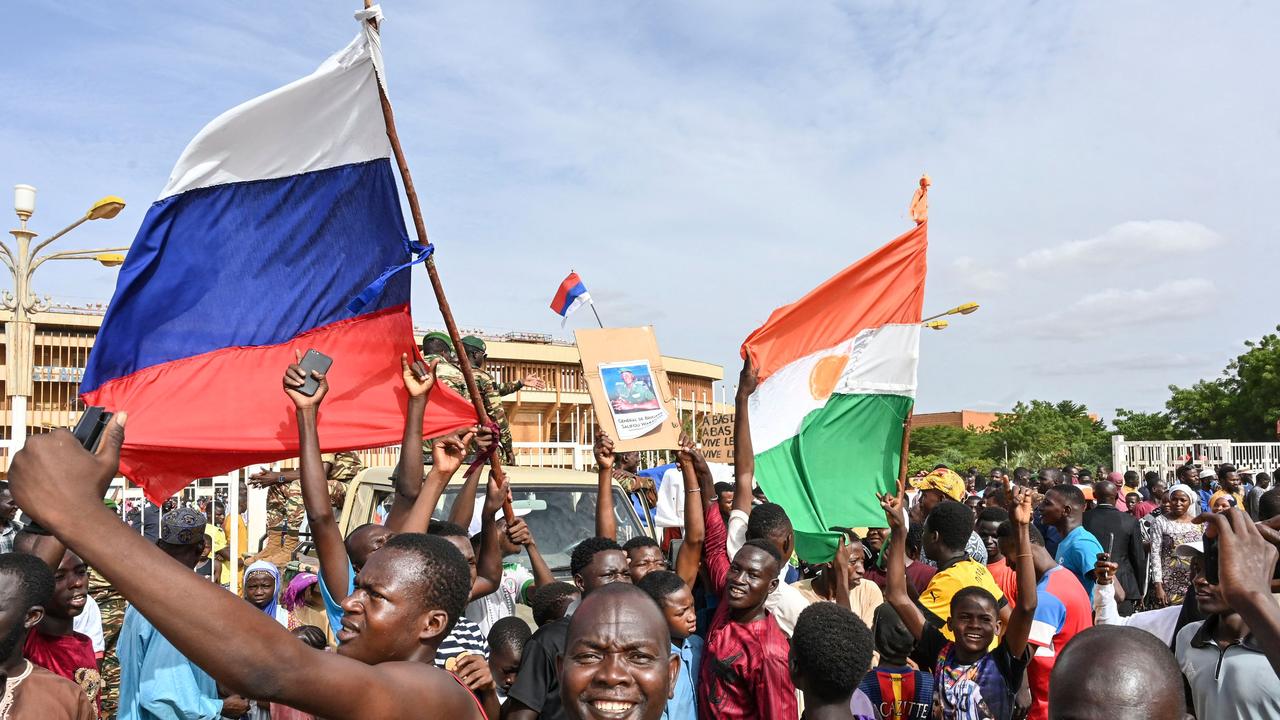 Supporters of Niger's National Council for the Safeguard of the Homeland (CNSP) wave Niger and Russian flags. Picture: AFP