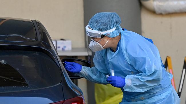 Health workers dressed in Personal Protection Equipment (PPE) conduct COVID-19 testing. Picture: NCA NewsWire/Bianca De Marchi