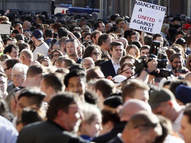 People attend a vigil in Albert Square, Manchester, England.  Picture:  AP