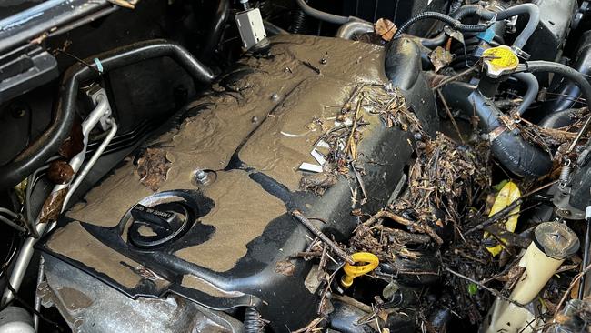 The engine of the Toyota Yaris parked near Nambour Plaza was submerged, and covered in mud. The car was not insured. Photo: Mark Furler