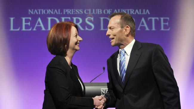 Gillard shakes hands with then-opposition leader Tony Abbott ahead of the 2010 leaders debate at the National Press Club in Canberra.