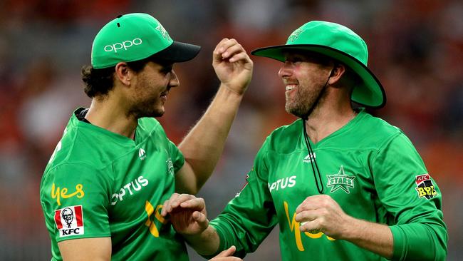 Ben Dunk (right) celebrates with Nathan Coulter-Nile after catching Chris Jordan of the Scorchers. Picture: AAP