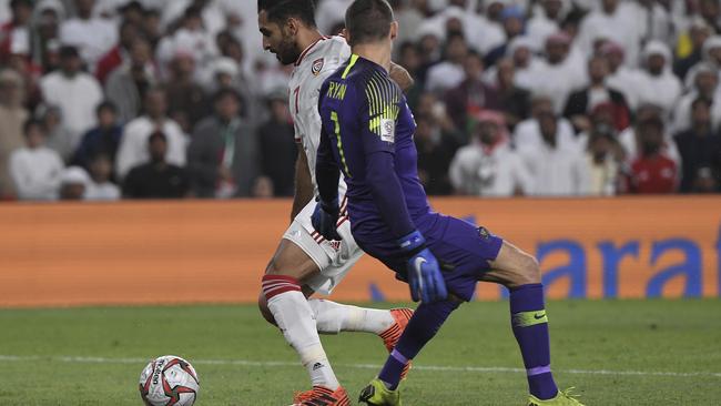 United Arab Emirates' forward Ali Mabkhout al Hajeri, left, dribbles past Australia's goalkeeper Mat Ryan to score his side's goal. Picture: Hassan Ammar/AP