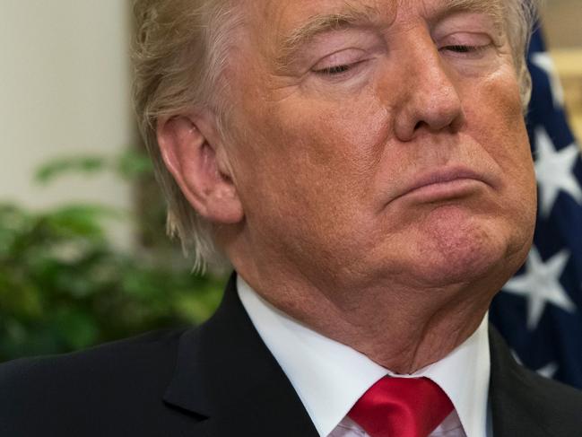 US President Donald Trump looks on during the announcement of a a newly designed, Made in America pharmaceutical glass bottle jointly developed by Merck, Pfizer and Corning during a Made in America Week event in the Roosevelt Room of the White House in Washington, DC, July 20, 2017. / AFP PHOTO / SAUL LOEB